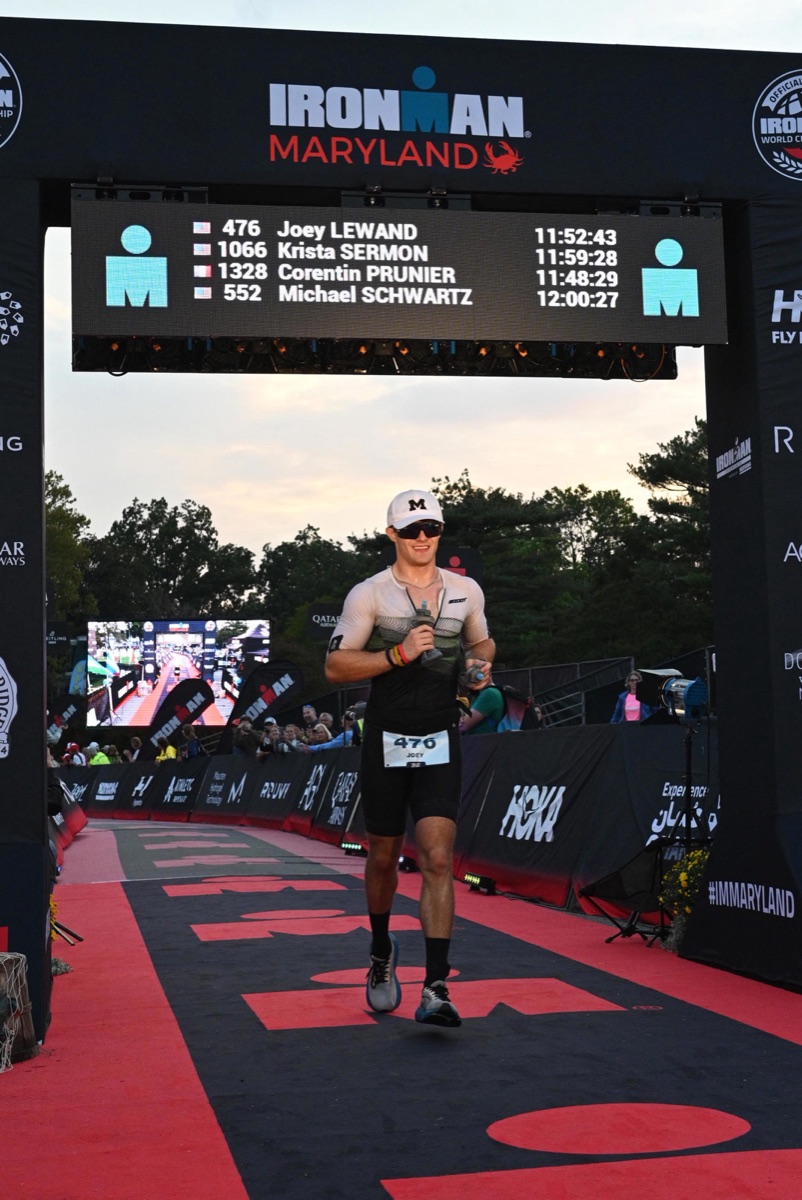 Joseph Lewand crossing the finish line at Ironman Maryland